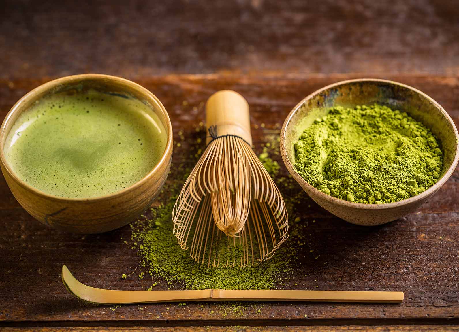 Premium matcha powder with traditional whisk and bowl